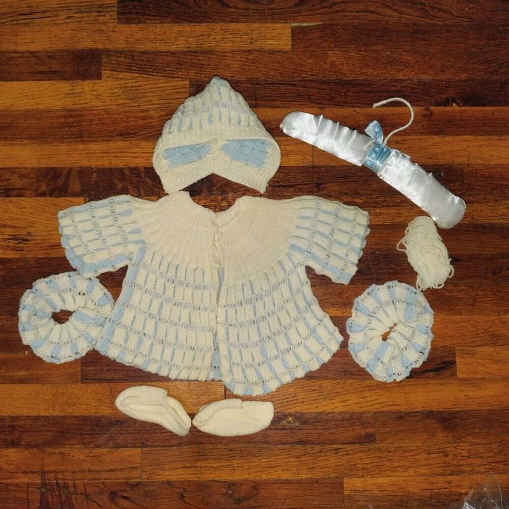 Unfinished knitted newborn outfit